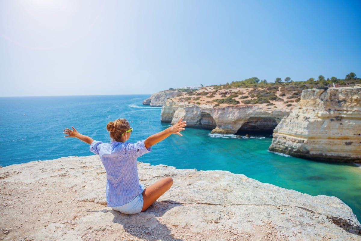 Female tourist overlooking coast in the Algarve