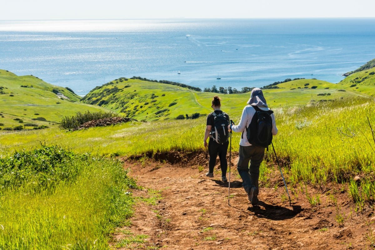 Hikers on Smugglers Road descending to Smugglers Cove on Santa Cruz Island, Channel Islands National Park, California