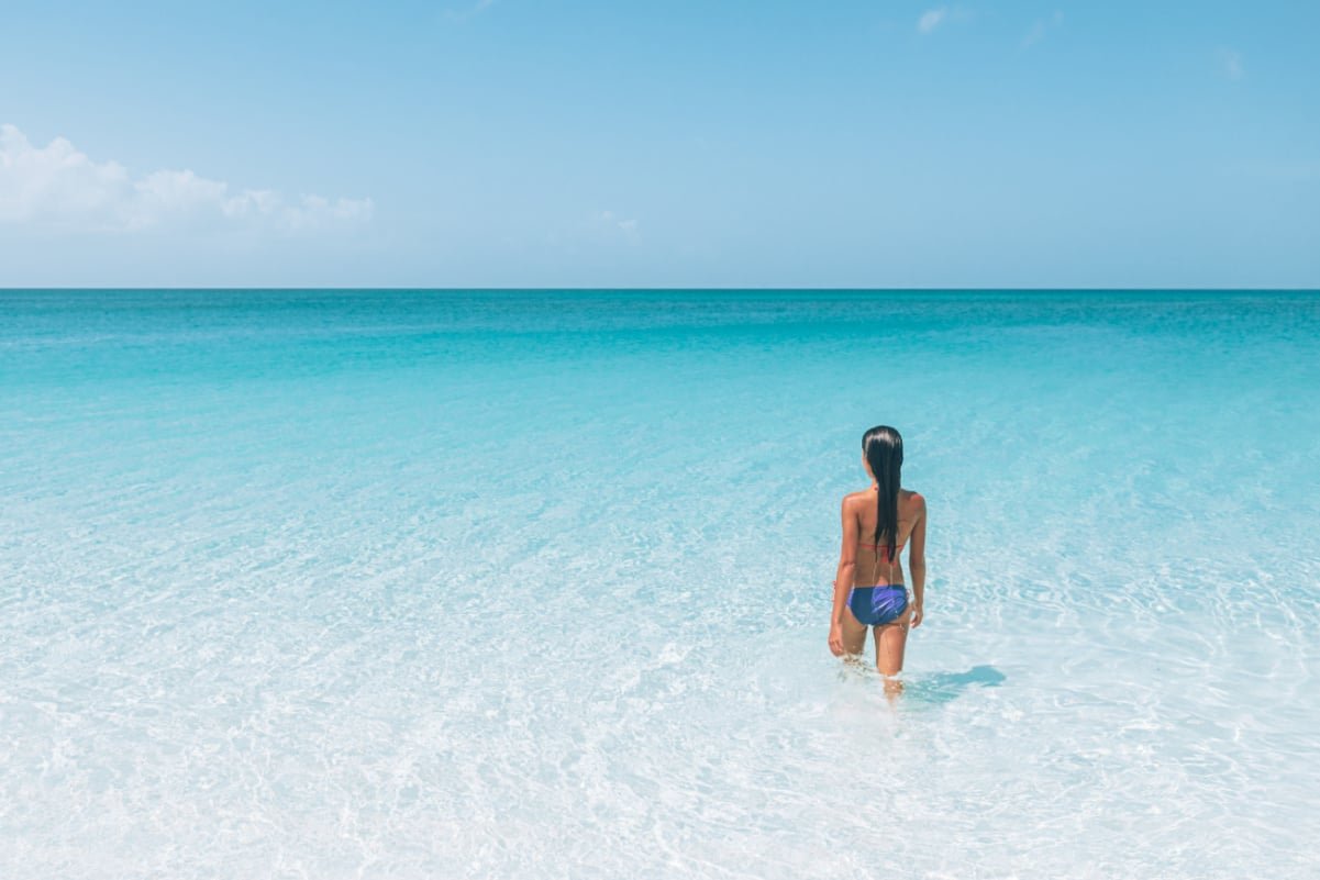 Woman walking into the ocean in South Caicos