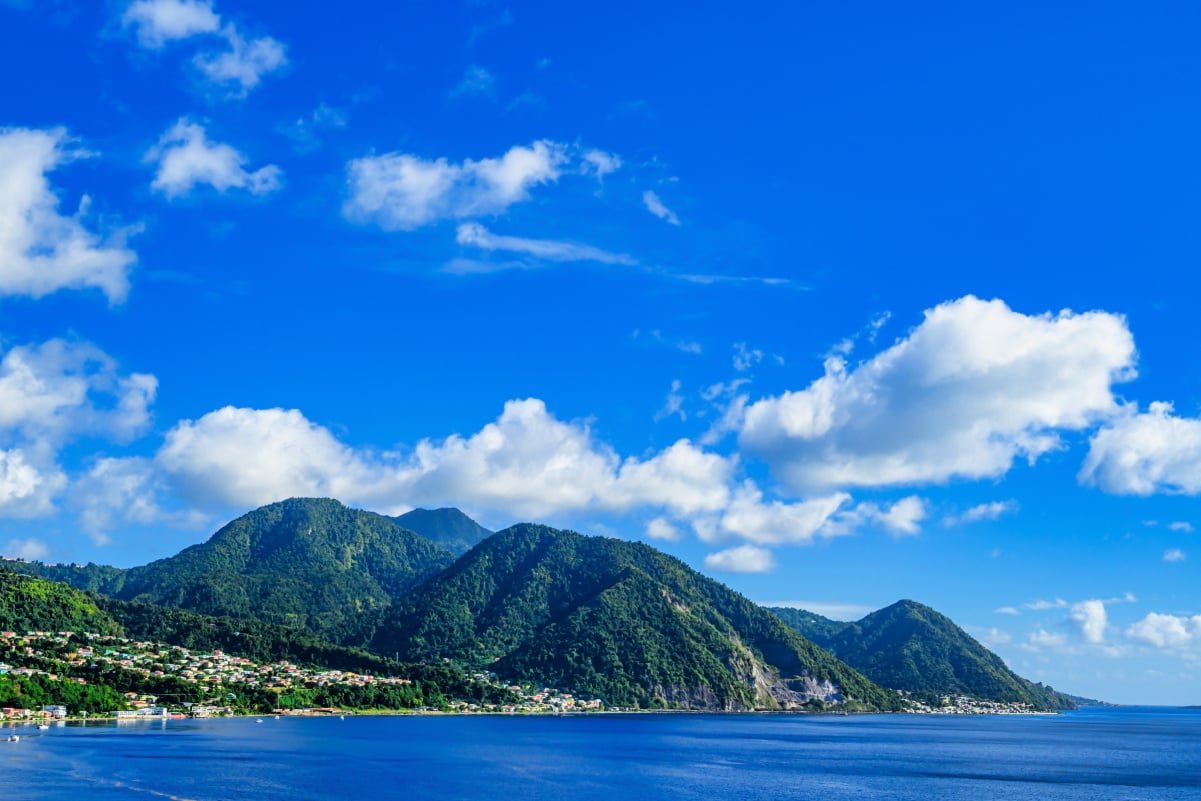 A view of the coast of Dominica and the jungle under a blue sky with beautiful clouds