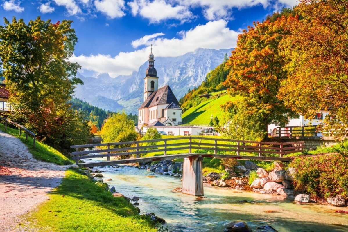 Ramsau, Berchtesgaden - Germany. Autumn scenery in Bavaria with Parish Church of St. Sebastian and River Ramsauer Ache.